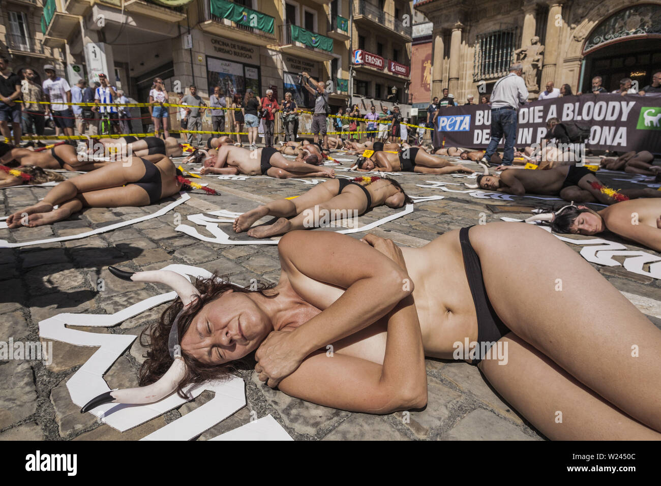 Pamplona, Navarra, Spain. 5th July, 2019. Activists against animal cruelty lie on the ground like dead bodies inside chalk outlines of bulls during a performance against bullfightings before the San Fermin celebrations in Pamplona, Spain. Credit: Celestino Arce Lavin/ZUMA Wire/Alamy Live News Stock Photo