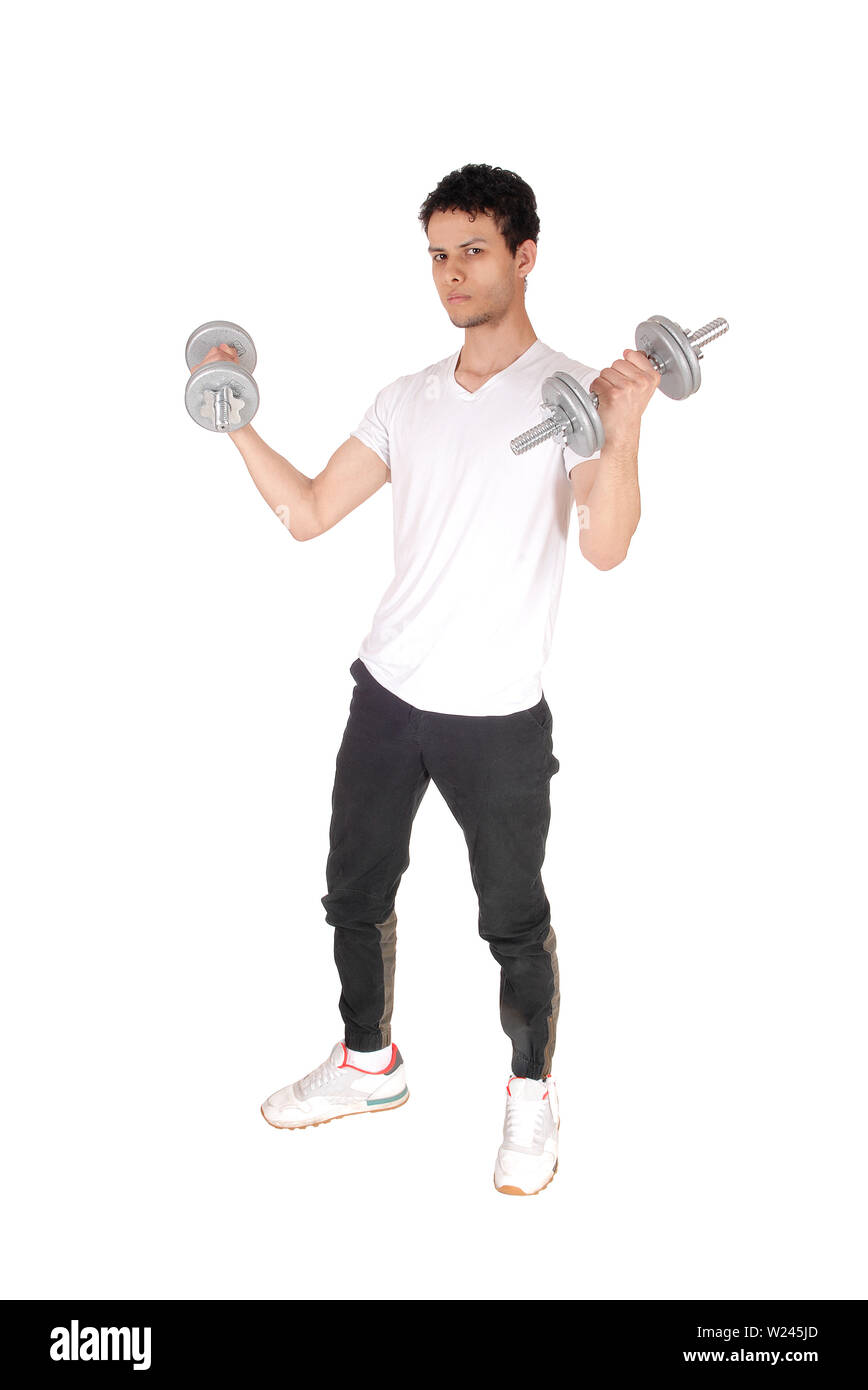 A handsome young man standing in the studio exercising with his two dumbbells, full length, isolated for white background Stock Photo