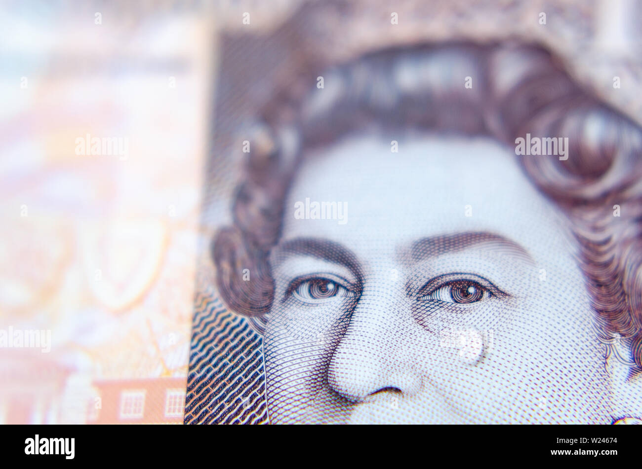 Macro photo of British pound banknote with a water tear drop as a tear on the Queen's face. Conceptual photo. Stock Photo