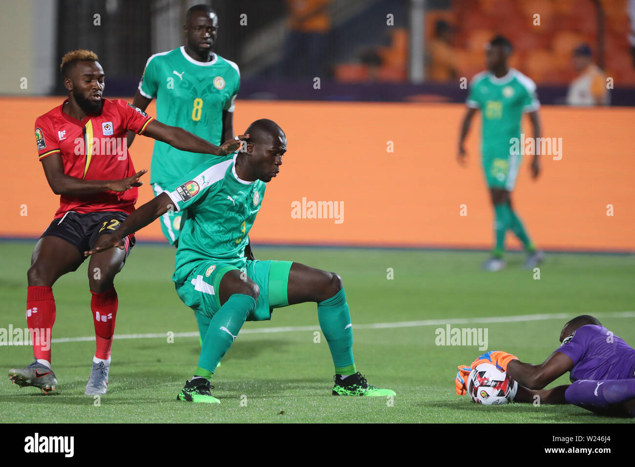 Cairo, Egypt. 05th July, 2019. Senegal's Alfred Gomis (R) catches the ball before Uganda's Lumala Abdu (L) during the 2019 Africa Cup of Nations round of 16 soccer match between Uganda and Senegal at Cairo International Stadium. Credit: Gehad Hamdy/dpa/Alamy Live News Stock Photo