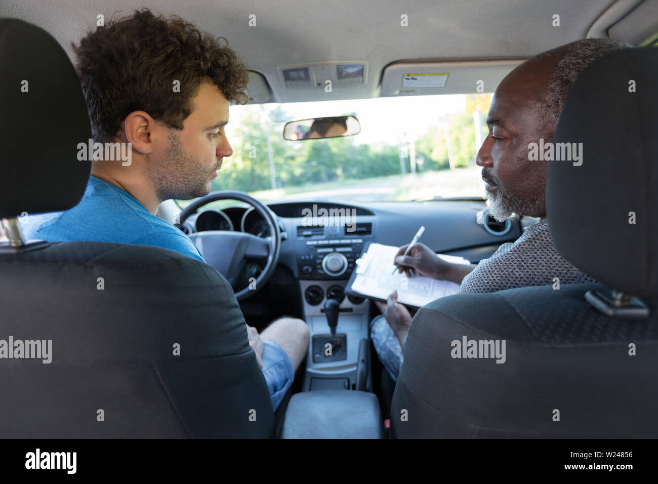 Driving Instructor And Student In The Front Of The Car Stock Photo