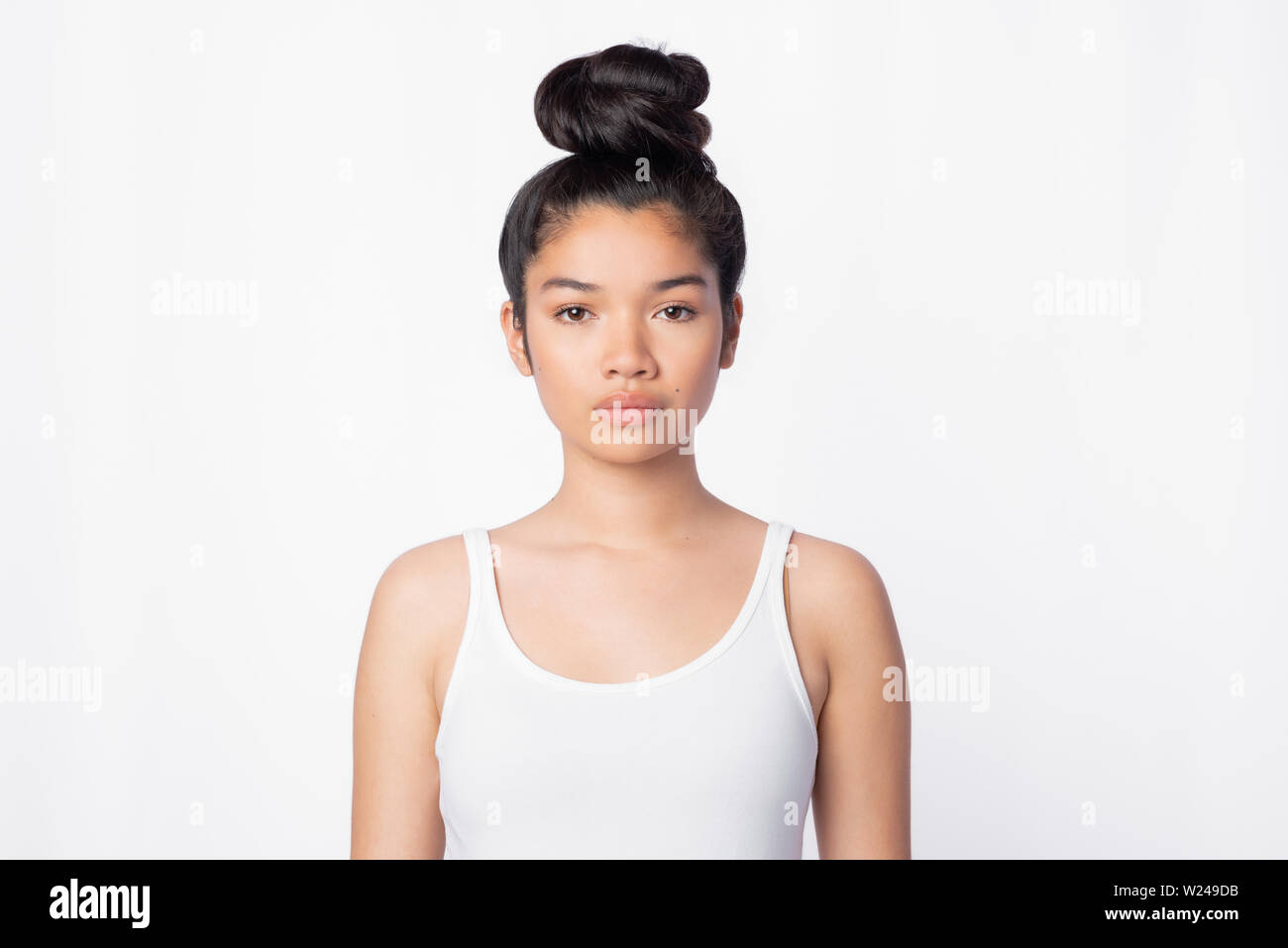 serious confident asian woman in white Top staring at camera Stock Photo
