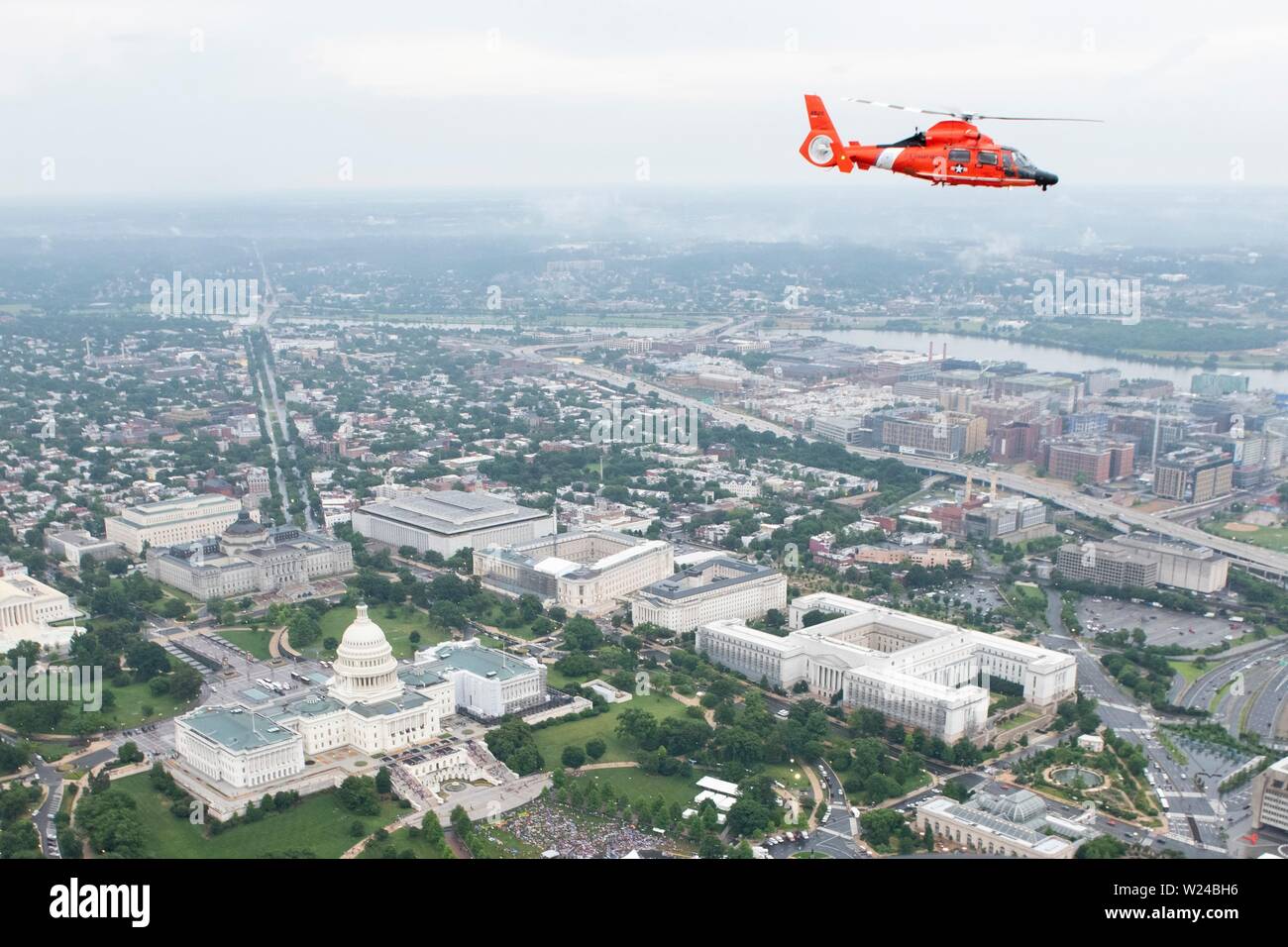 Washington DC, USA. 04th July, 2019. Aerial view of a U.S. Coast Guard MH-65 Dolphin helicopter as it flies in formation over the National Mall during the Salute to America event at the Lincoln Memorial July 4, 2019 in Washington, D.C. Credit: Planetpix/Alamy Live News Stock Photo