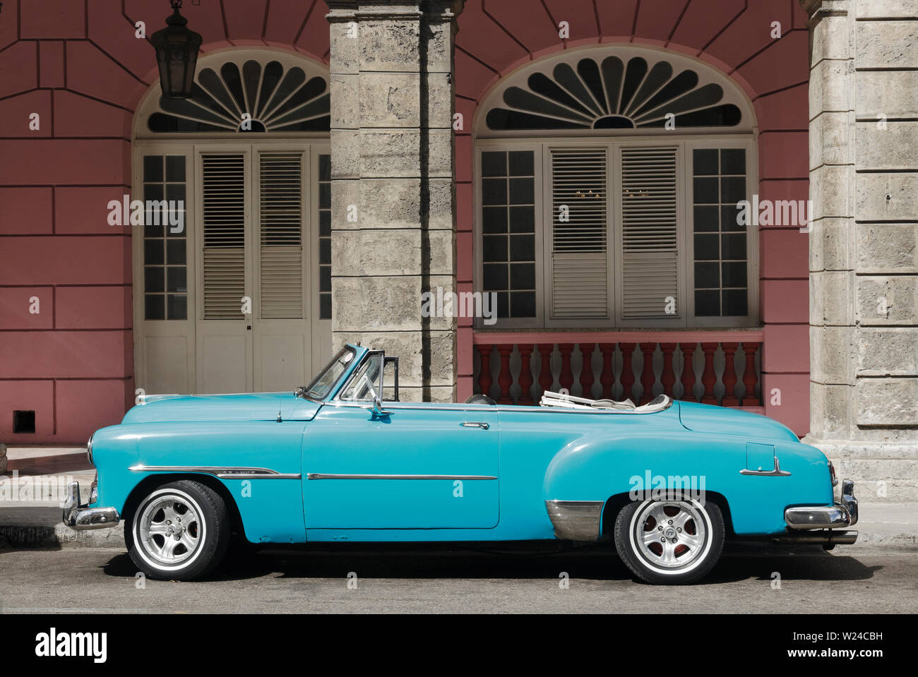 Classic American car parked on the street in Havana, Cuba. Vintage Turquoise Chevy in front of building. Stock Photo