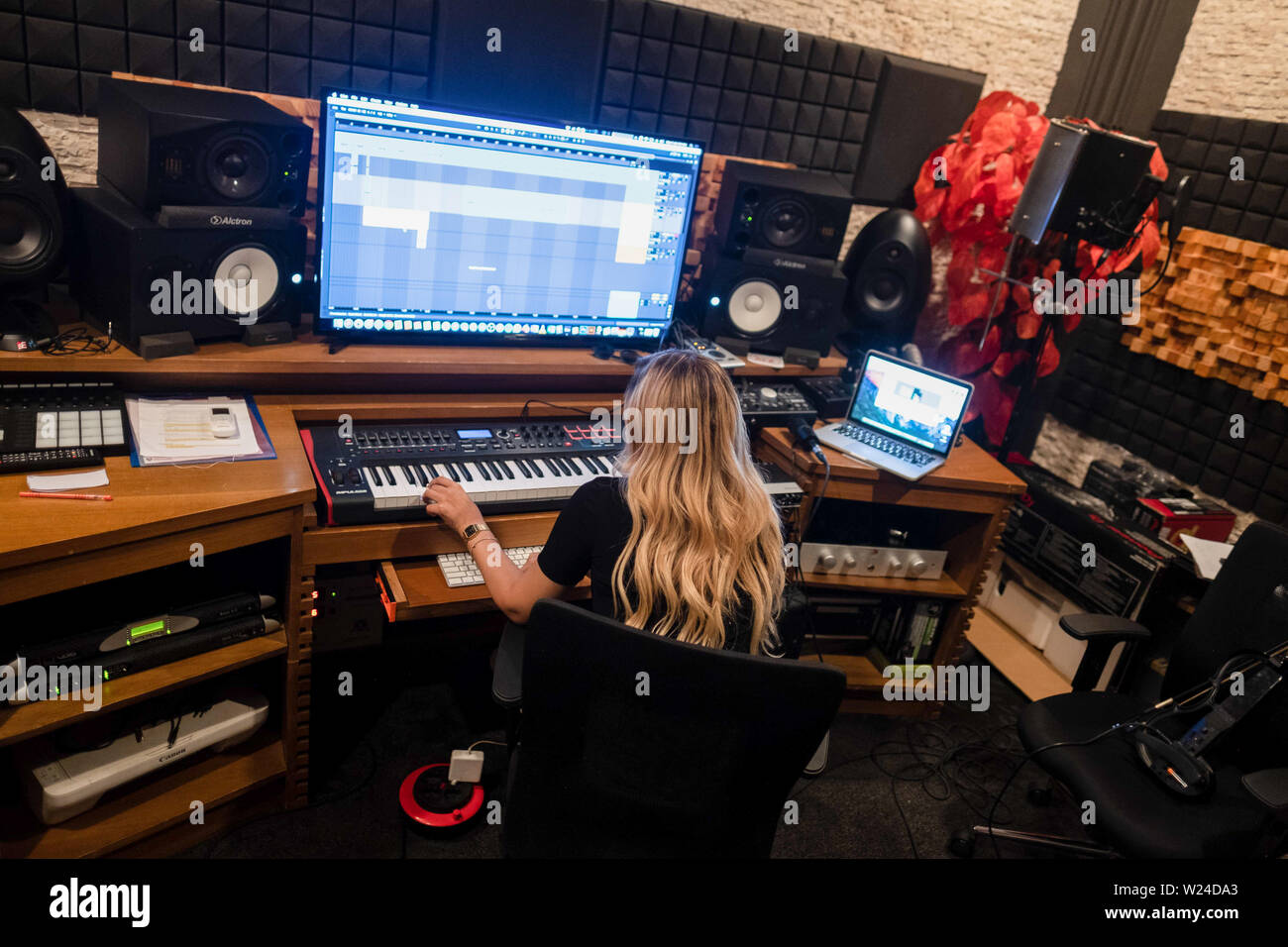 Music studio full of instruments and pc display Stock Photo - Alamy