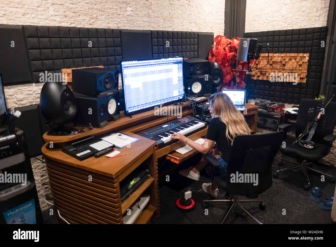Female Musician Working In A Modern Music Recording Studio