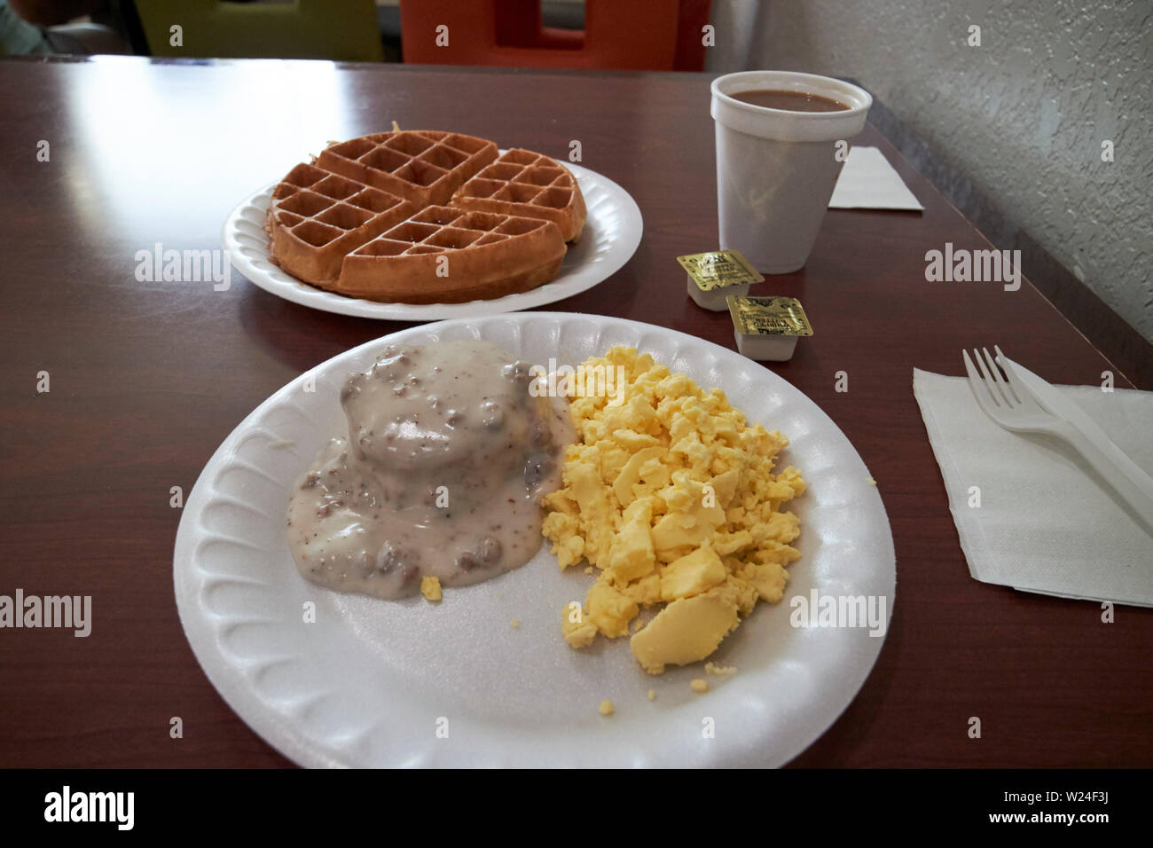 cheap hotel breakfast of biscuits and gravy, eggs, waffle and coffee