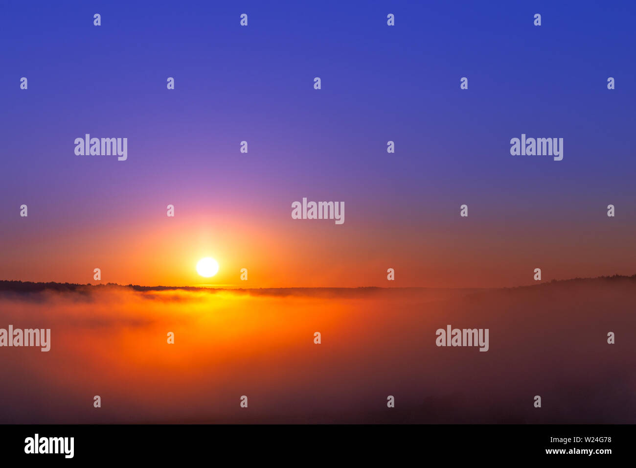 Sun Rise Without Editing golden-blue summer sunrise over fog without clouds in minimalistic ...
