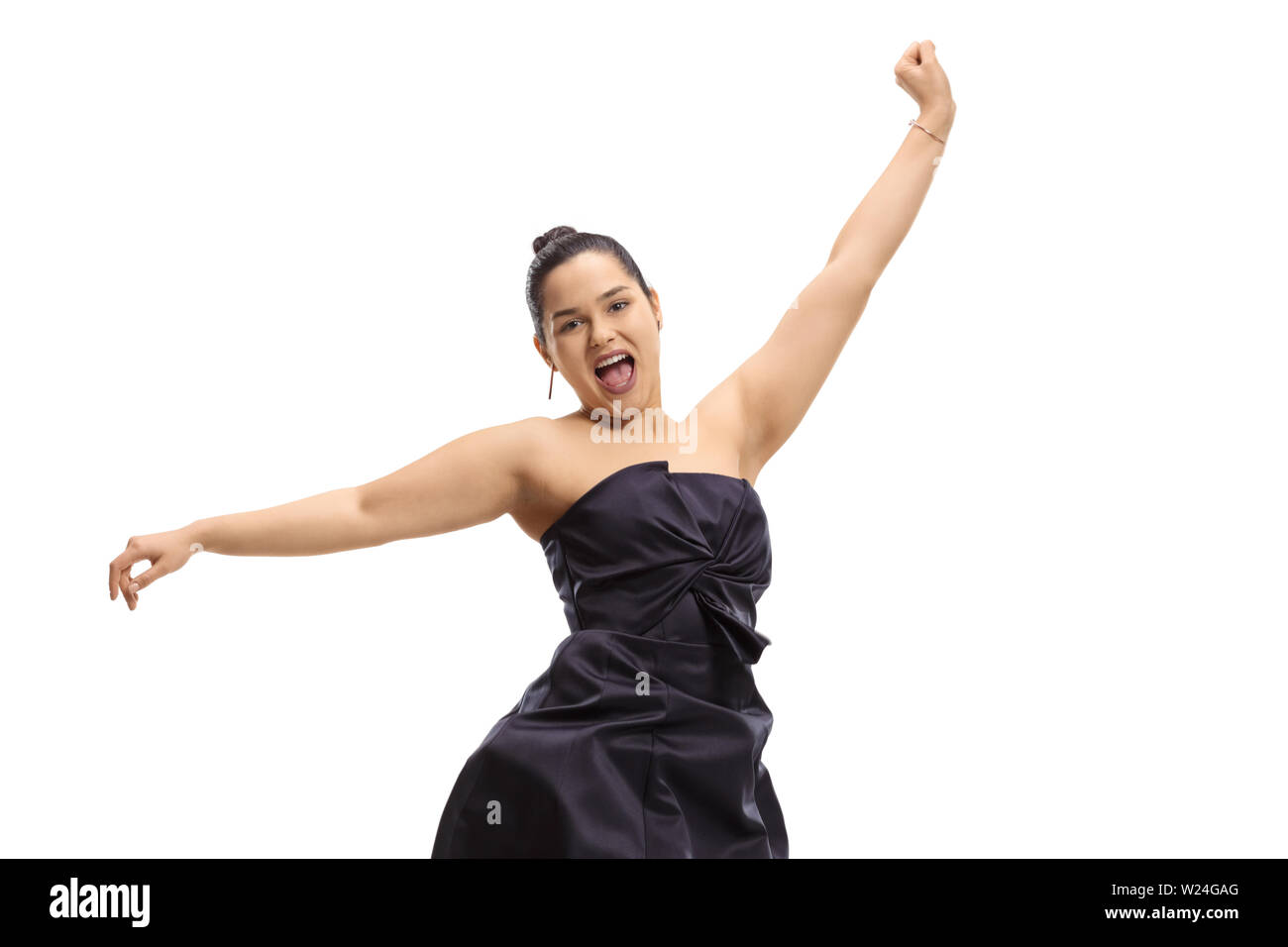 Young woman in an elegant dress jumping and gesturing happiness isolated on white background Stock Photo
