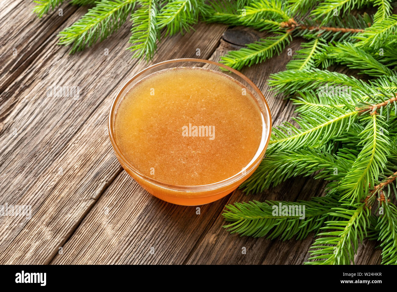 Homemade syrup against cough made from young spruce branches in spring Stock Photo