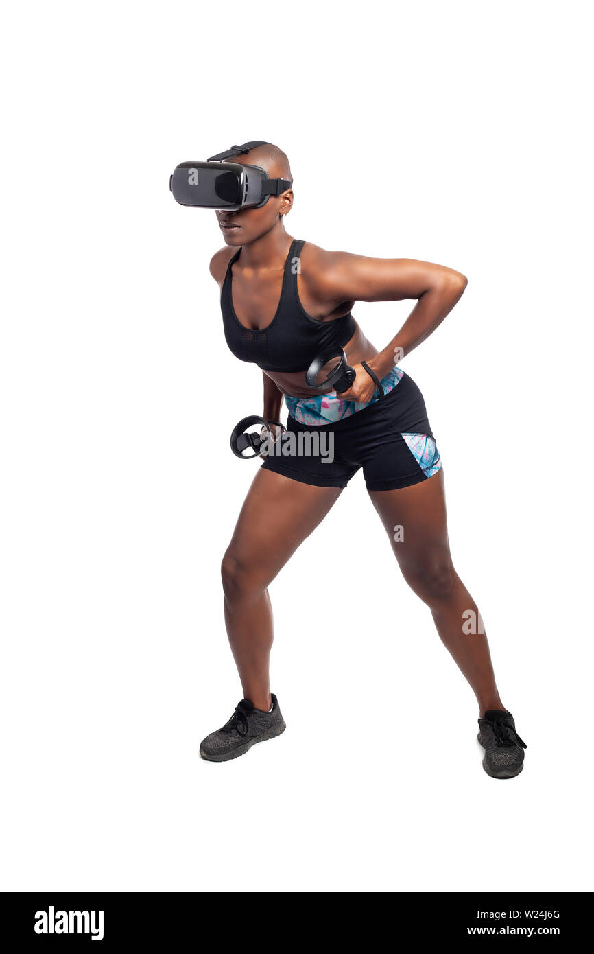 Athletic black female gamer wearing a vr headset and exercising in a