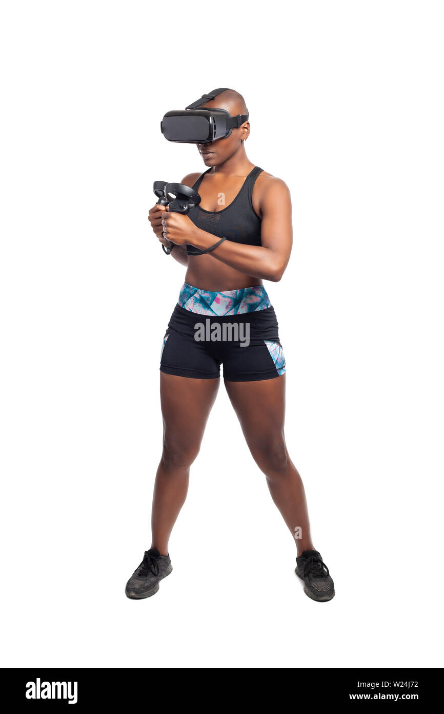 Athletic black female gamer wearing a vr headset and exercising in a