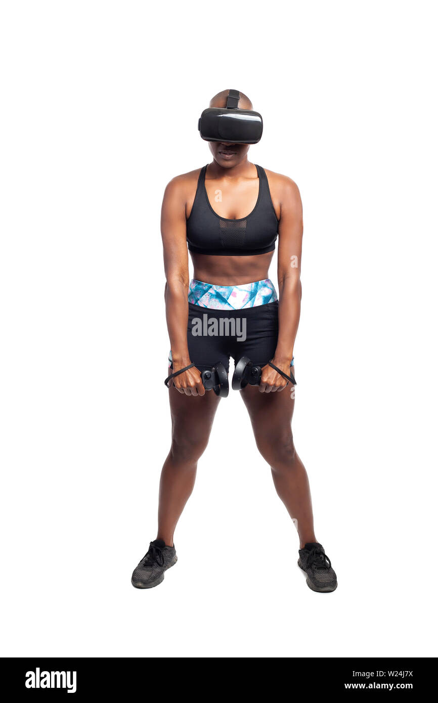 Athletic black female gamer wearing a vr headset and exercising in a