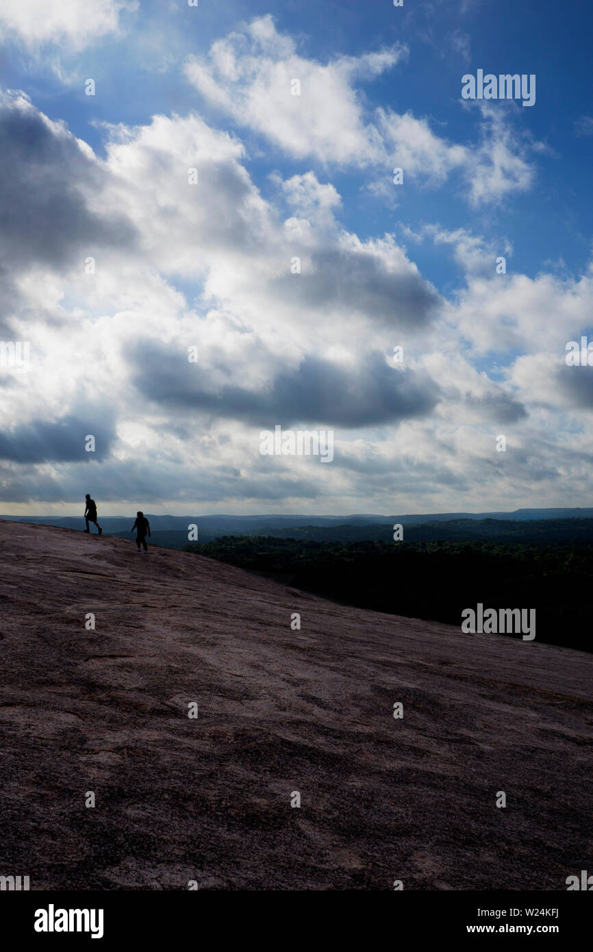 Two hikers climb Enchanted Rock Stock Photo - Alamy