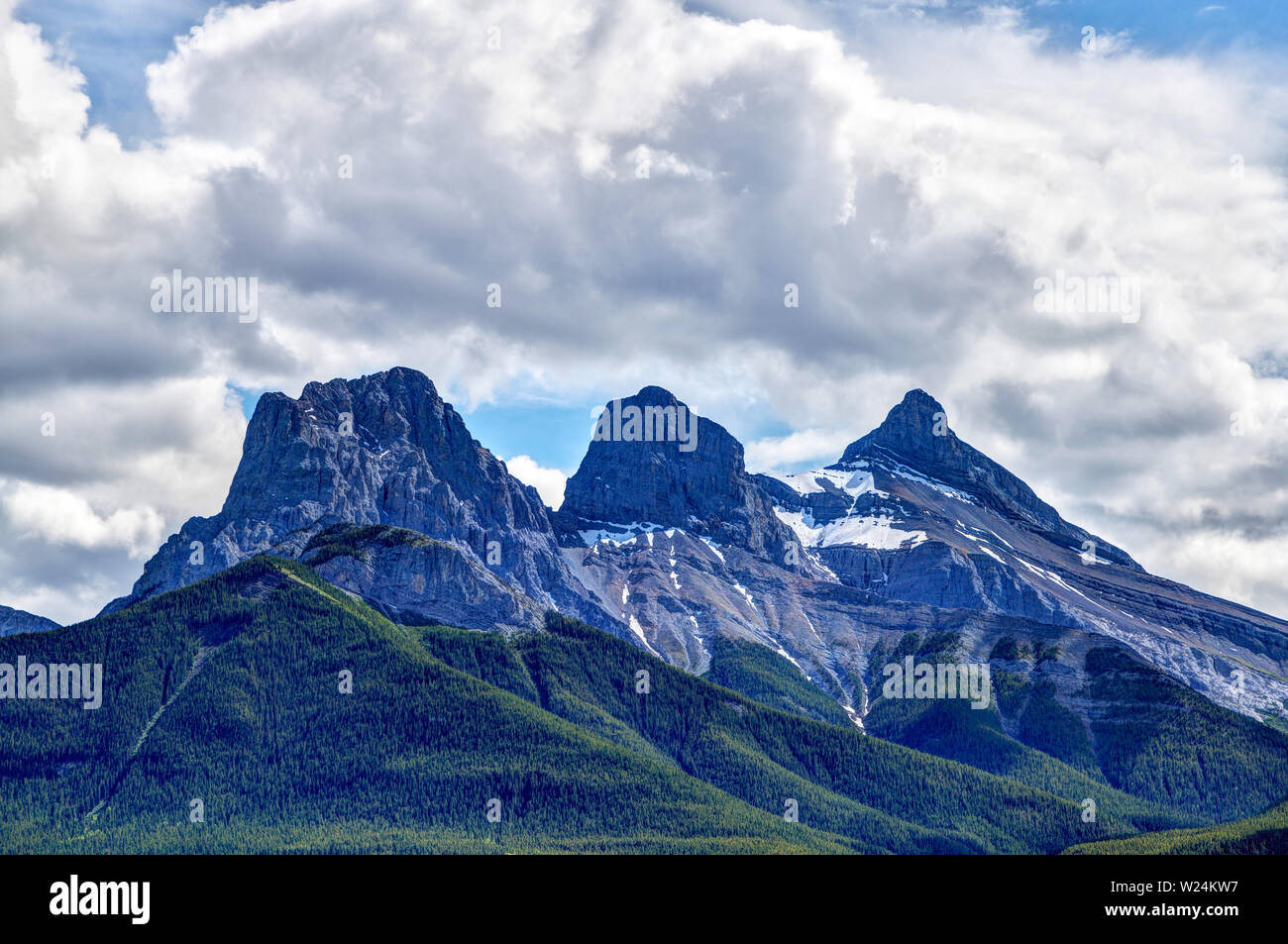 Close up of the iconic Three Sisters mountain peaks in the Canadian Rockies of Canmore, Alberta. The famous trio of peaks are named Faith, Charity and Stock Photo