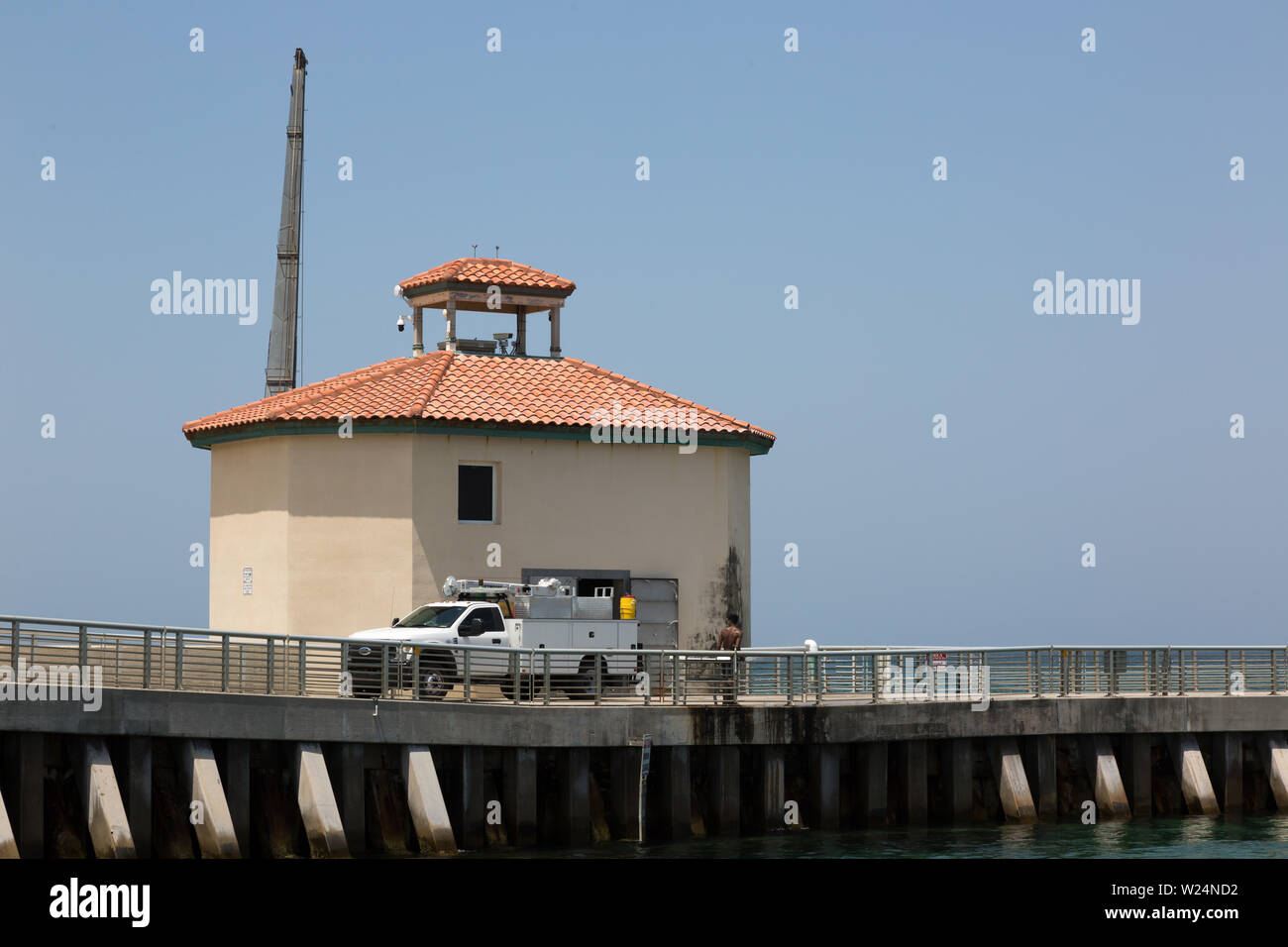 A work truck sits near a building at the end of the Boynton Inlet in Manalapan, Florida, USA. Stock Photo