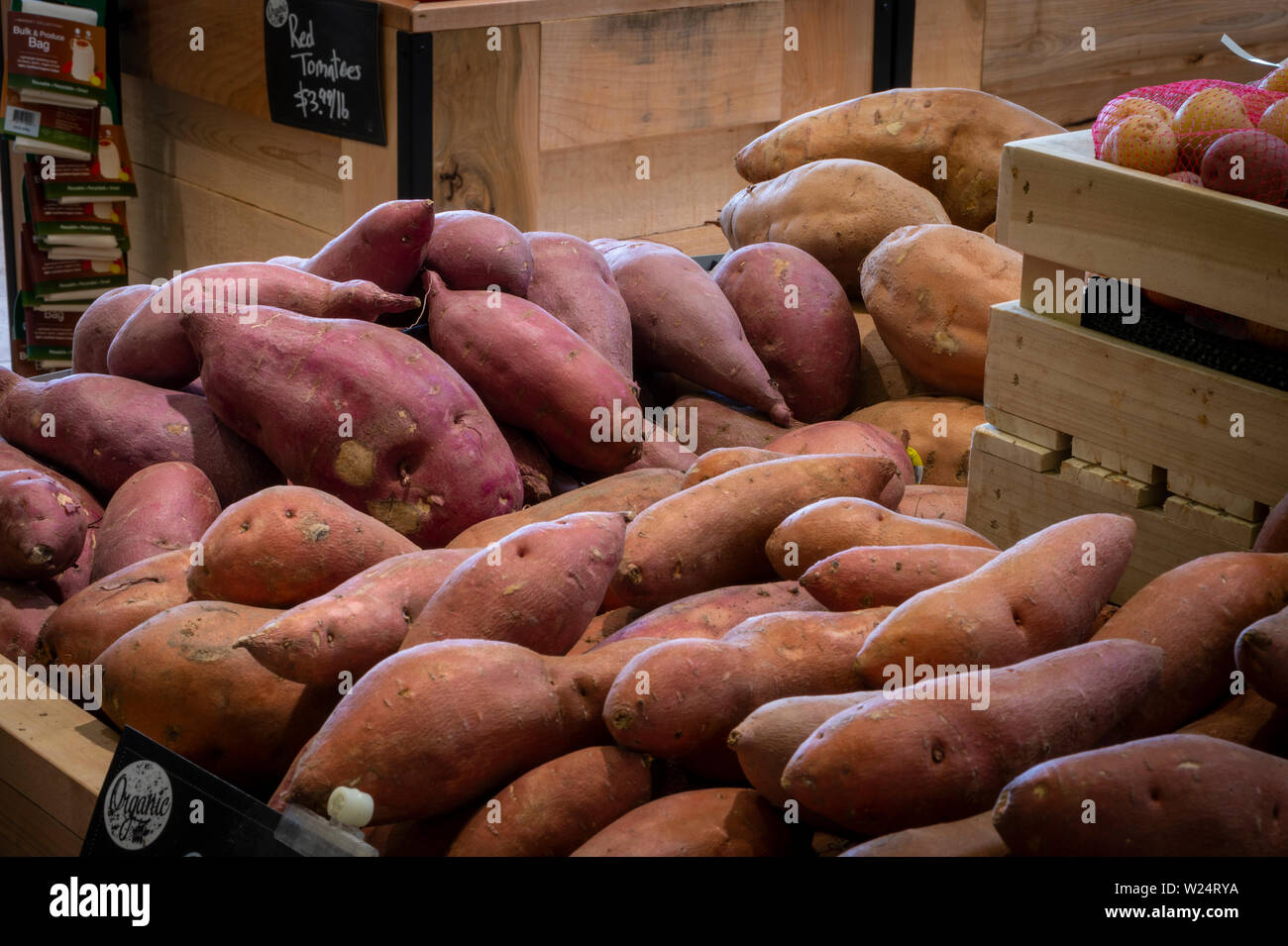 Sweet Potatoes & Yams For Sale In Produce Aisle in Grocery Store, USA Stock Photo