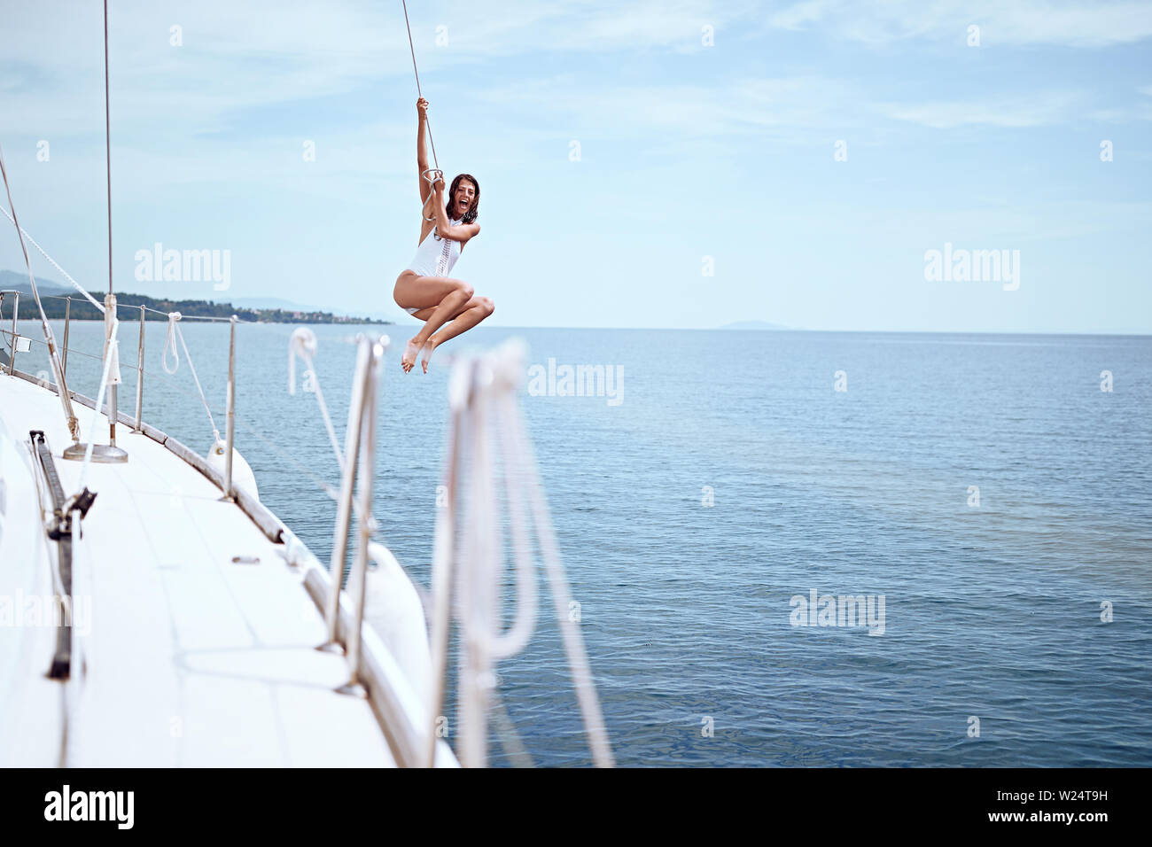 Young girl jumping from sailing boat in sea Stock Photo Alamy