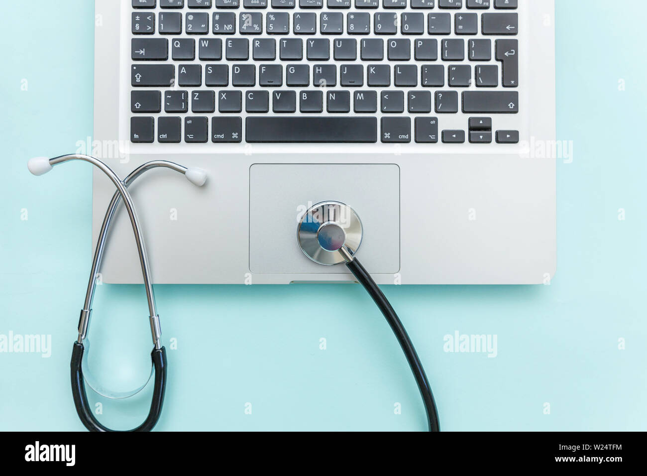 Stethoscope keyboard laptop computer isolated on blue background ...