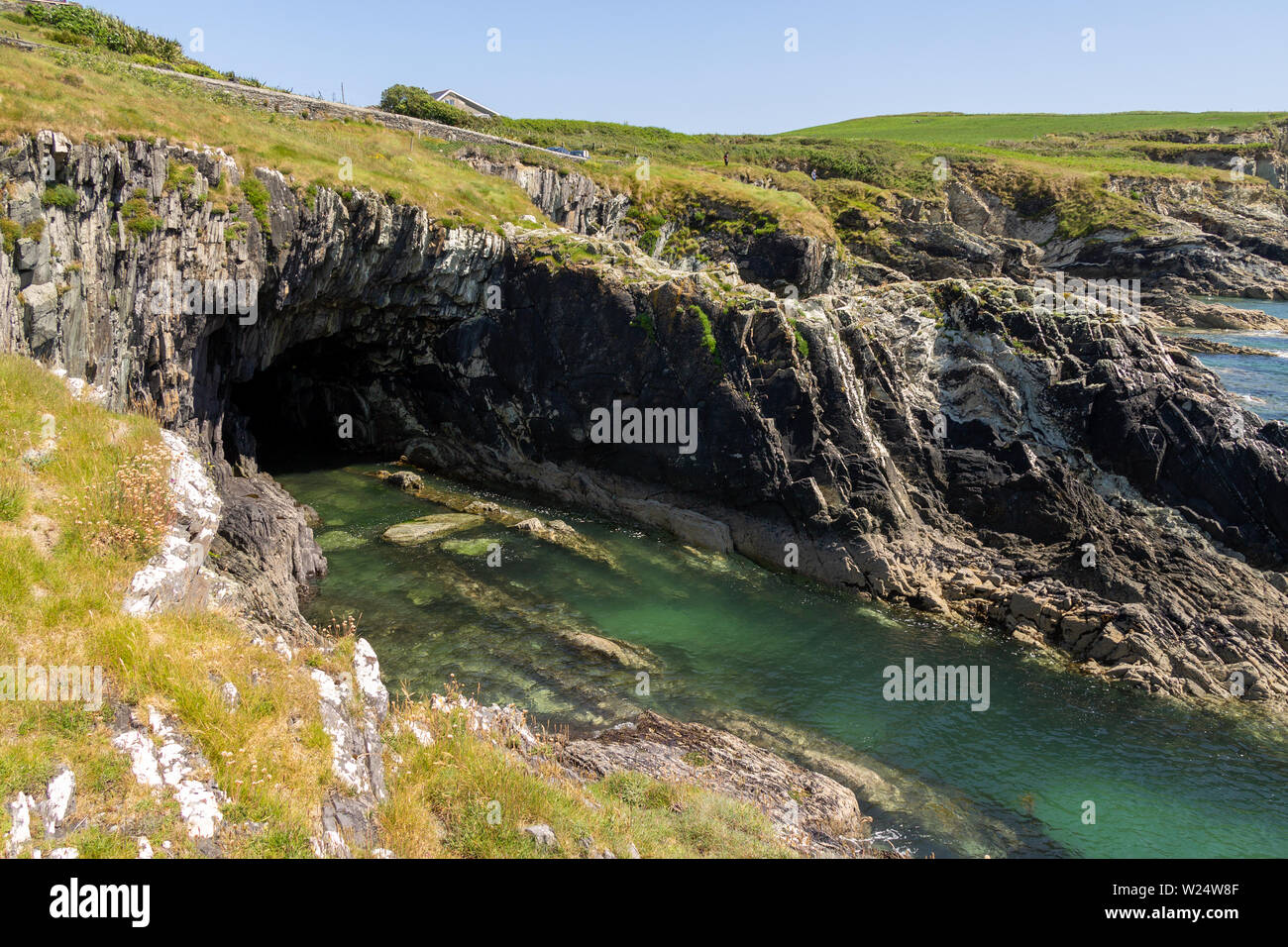 Sea cliff cave caused by coastal erosion Stock Photo