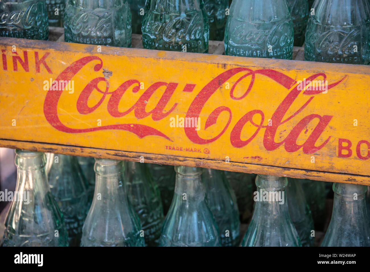 Vintage wooden Coca-Cola crate with glass Coca-Cola bottles. Stock Photo