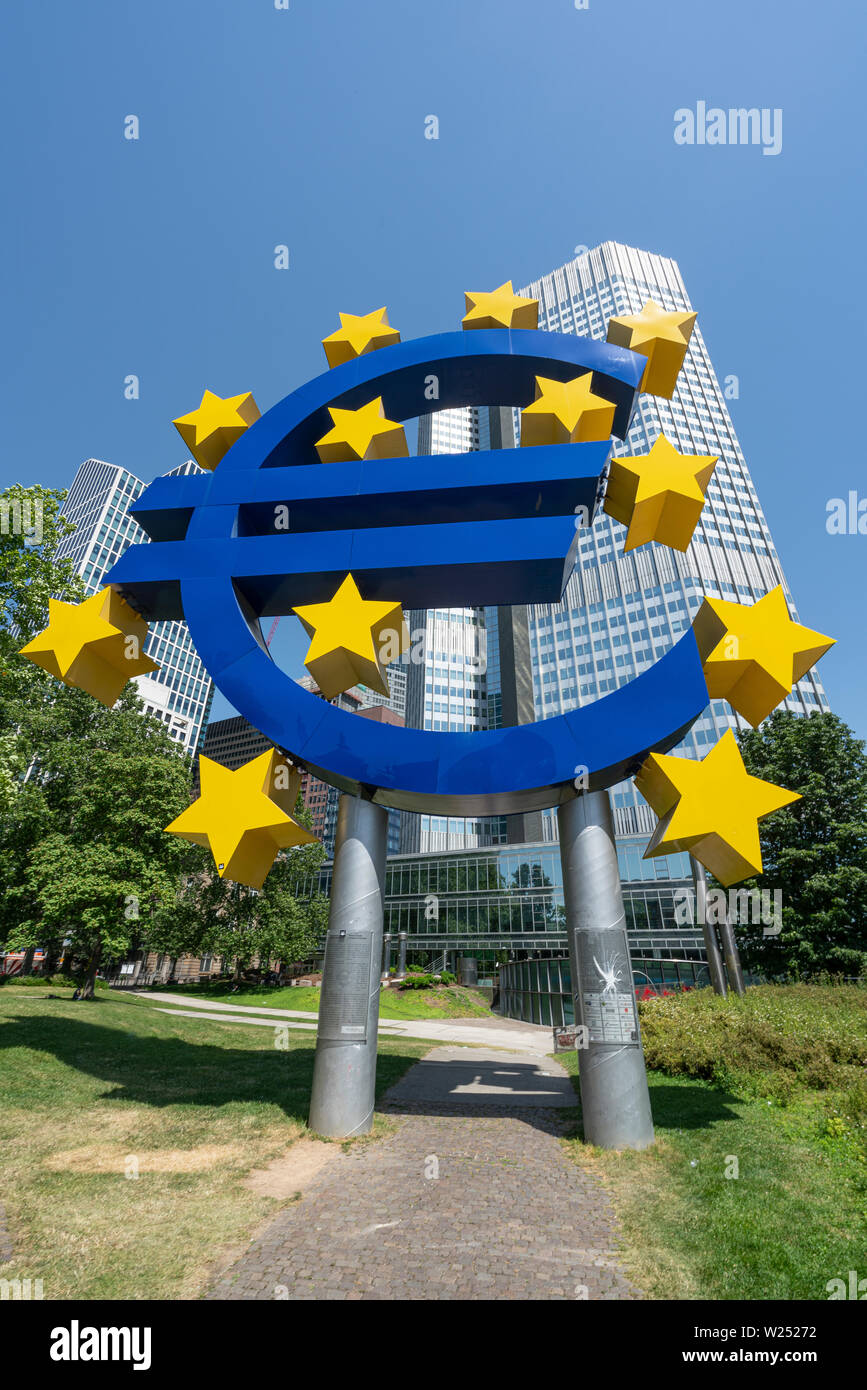 Frankfurt, Germany. July 2019.  The Symbol of Euro monument in front of the Eurotower Stock Photo