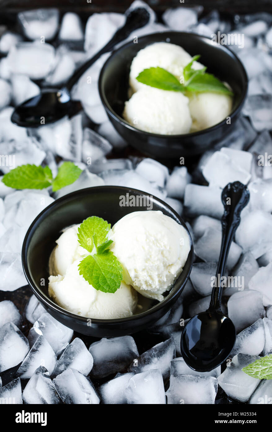 Vanilla ice cream in black bowl Stock Photo - Alamy