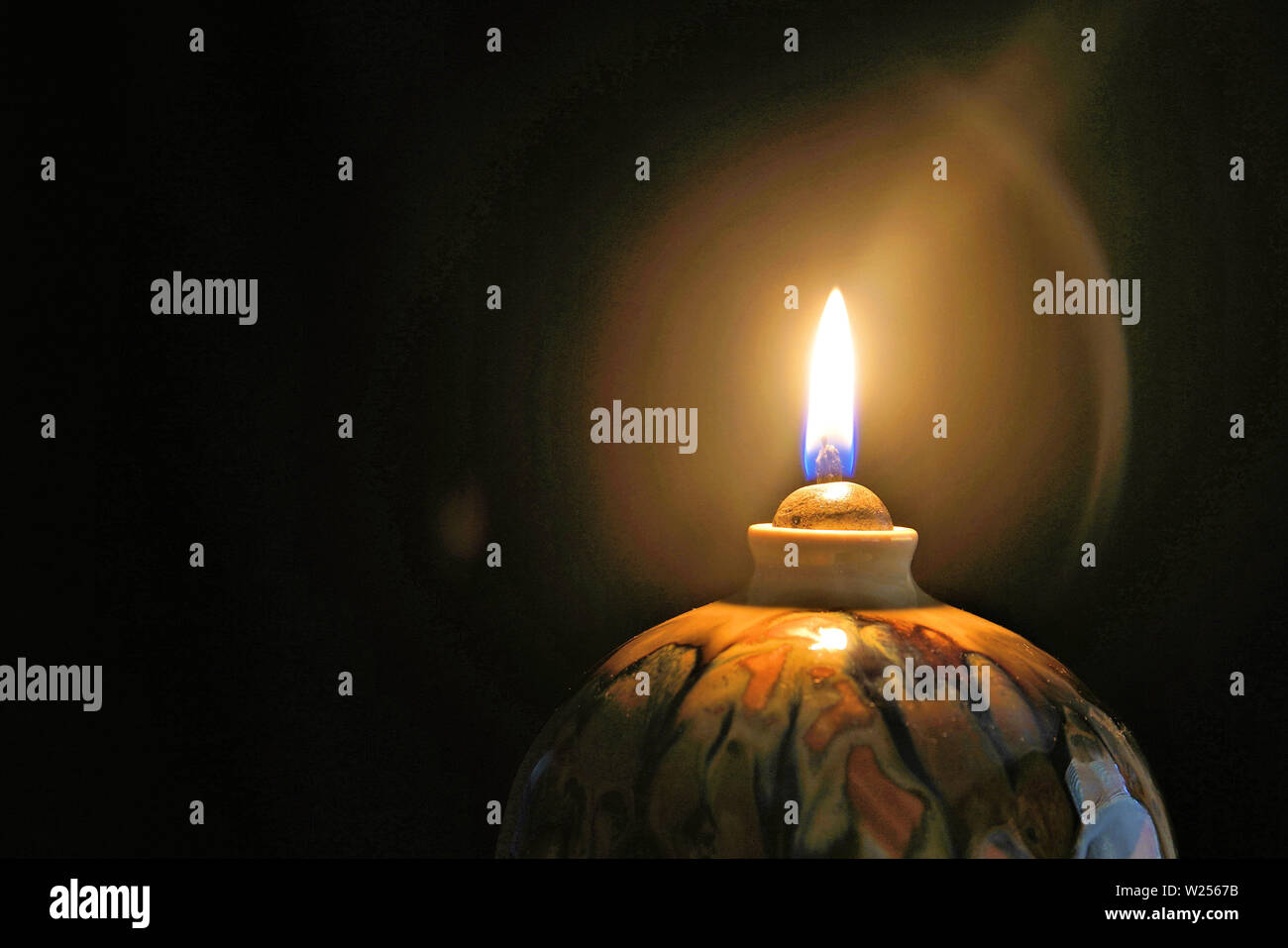 Oil lamp candle flame in the dark with halo effect Stock Photo Alamy