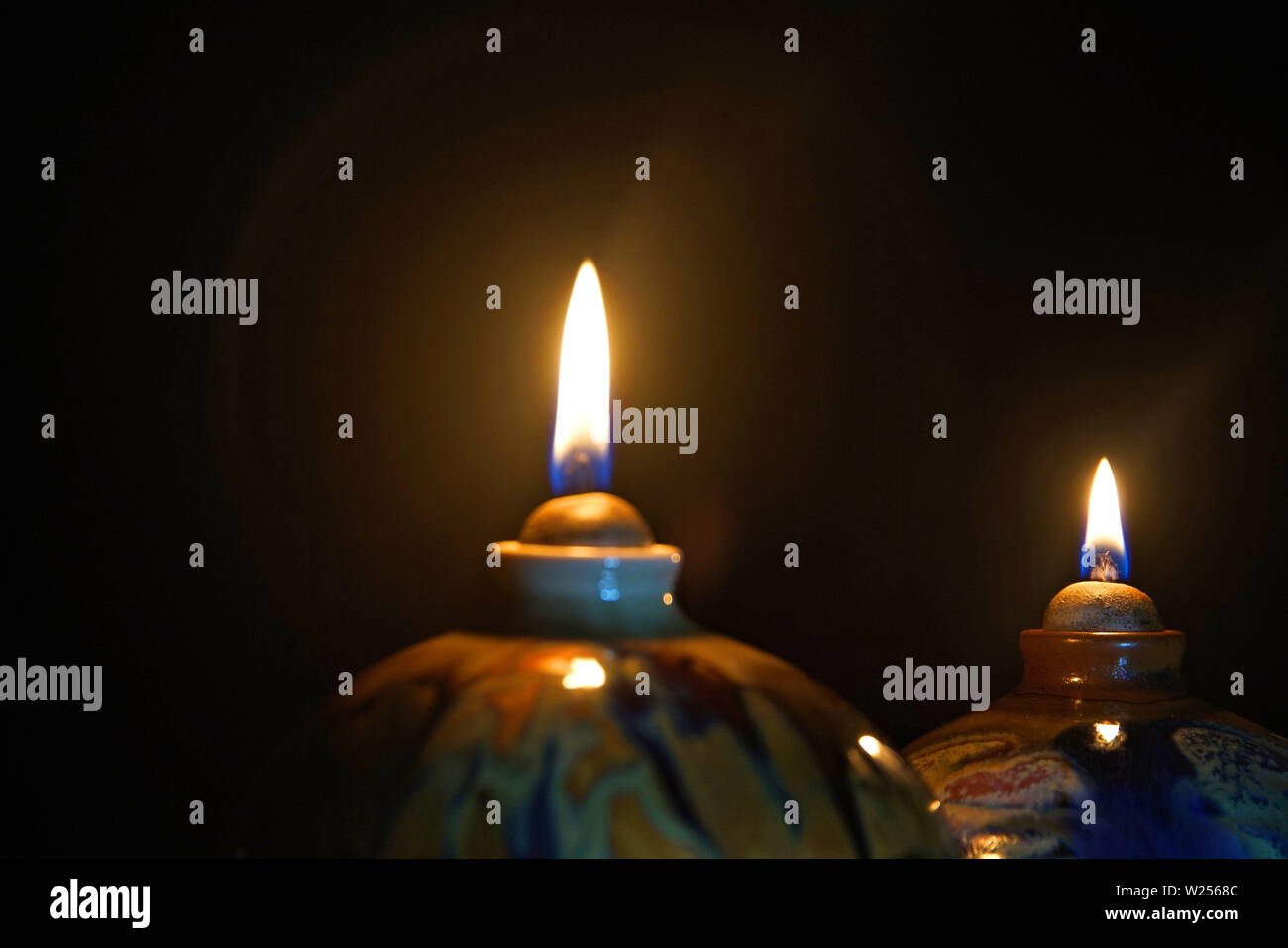 Oil lamp candle flame in the dark with halo effect Stock Photo