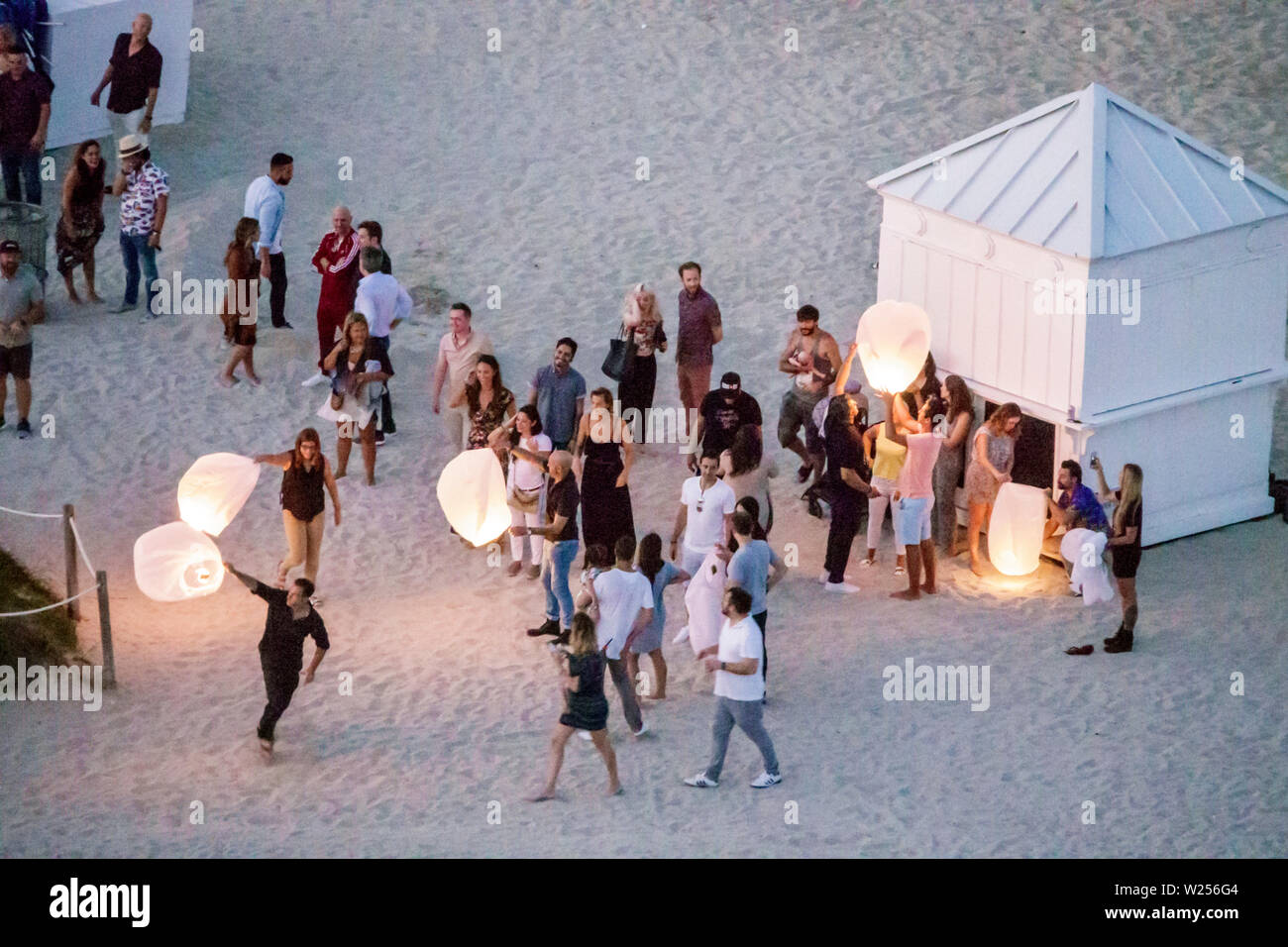 Miami Beach Florida,North Beach,sky lantern,Kongming Chinese lantern,paper hot air balloon,launching,Hispanic man men male,woman female women,boy boys Stock Photo