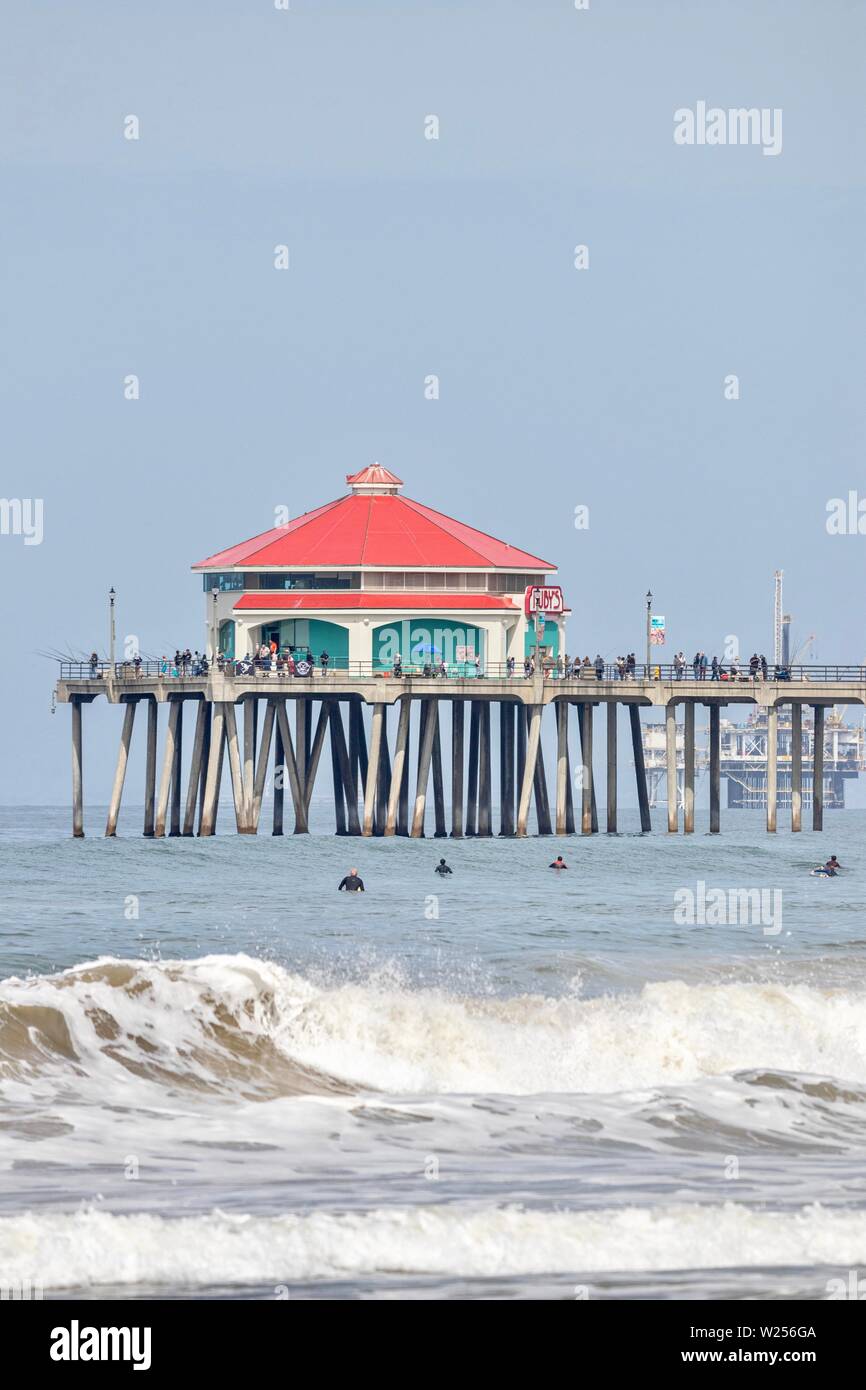 Huntington Beach Pier with surfers in the water Stock Photo