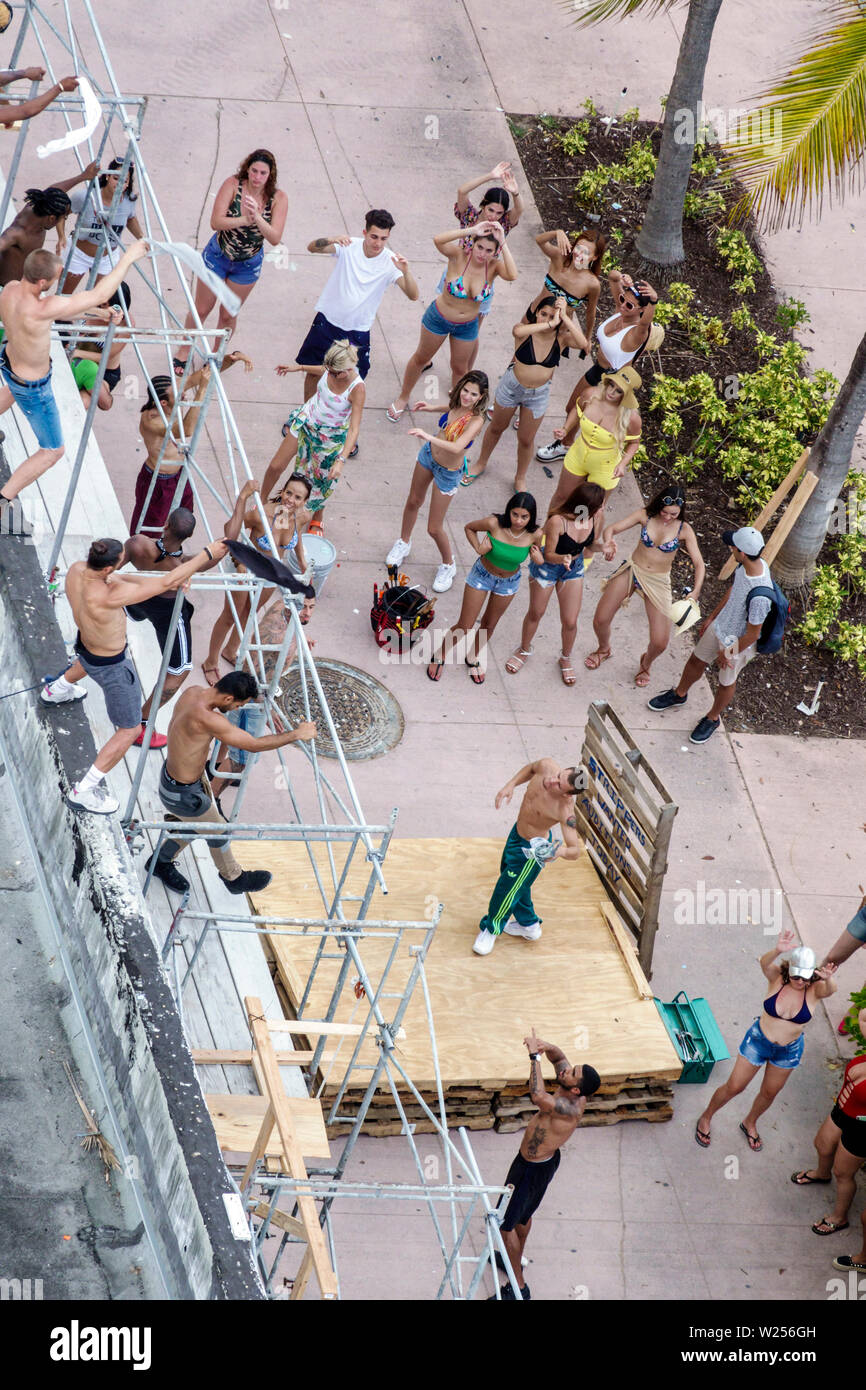 Miami Beach Florida,North Beach,Ocean water Terrace,male strip club,movie shoot,dancers,scaffolding,teens,young adults,adult adults woman women female Stock Photo