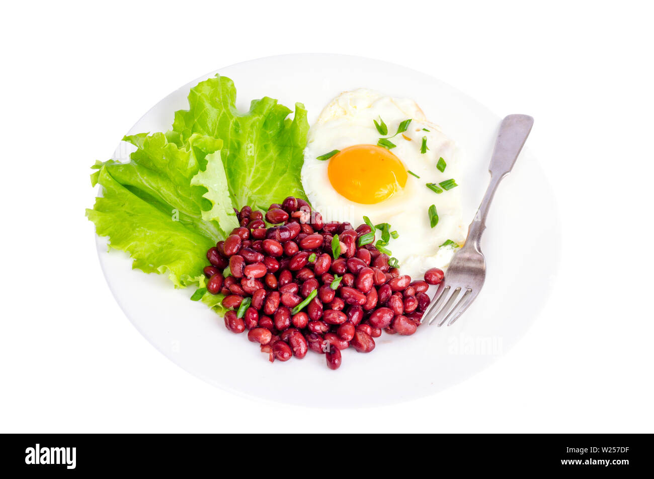 Red beans, lettuce and fried egg for breakfast. Stock Photo