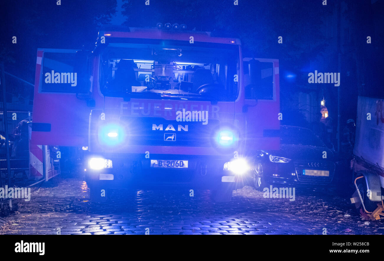Berlin, Germany. 06th July, 2019. An emergency vehicle of the fire brigade stands at a residential building in the Boddinstrasse in Neukölln. There a fire had broken out early in the morning in a ground floor apartment in a back building for reasons previously unknown. The fire brigade brought 13 people with escape hoods to safety, two of them were taken to hospital. Credit: Paul Zinken/dpa/Alamy Live News Stock Photo
