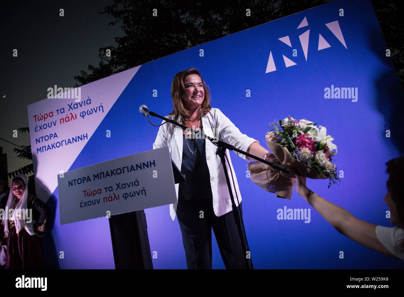 Chania, Greece. 05th July, 2019. A supporter gives flowers to Dora Bakoyannis after the event.Dora Bakoyannis, candidate MP for New Democracy in Chania and sister of Kyriakos Mitsotakis, leader of the New Democracy party, chairs a pre-election speech in Chania, Greece. New Democracy is SYRIZA's biggest competitor and possible new government in the Parliamentary elections. Credit: SOPA Images Limited/Alamy Live News Stock Photo