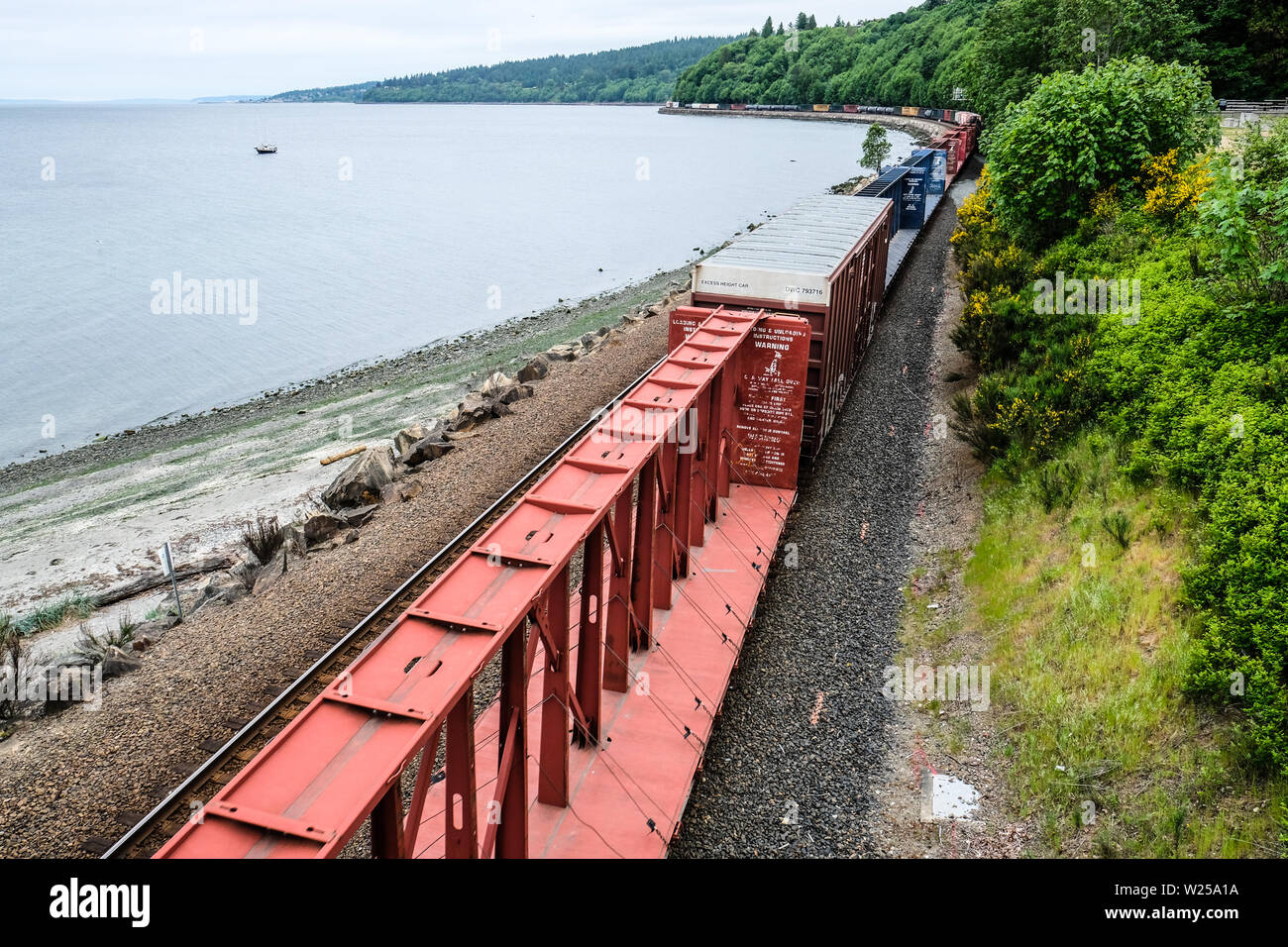 Long Northern Burlington freight train move along Puget Sound coastline ...