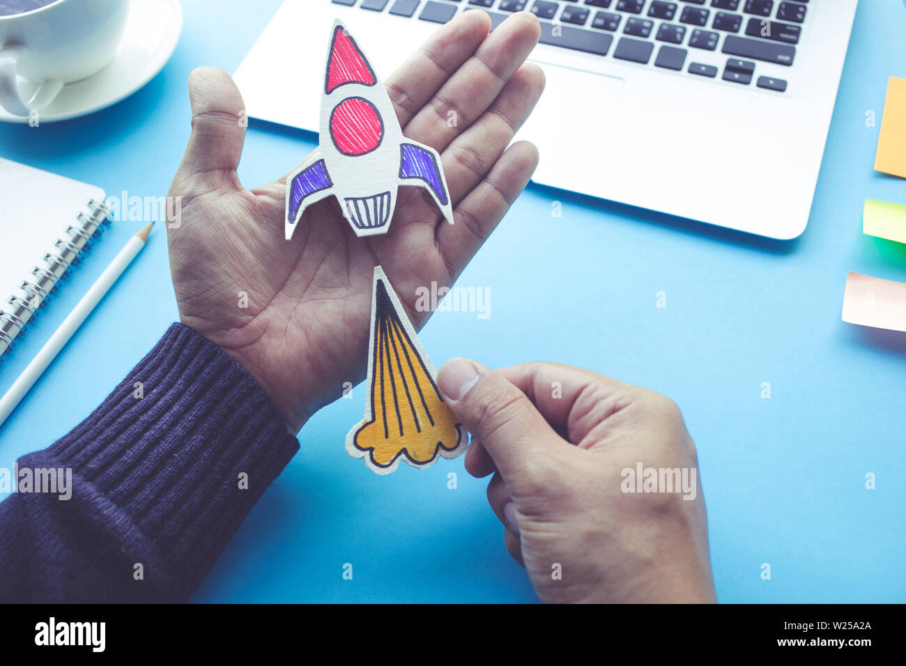Start up concepts with rocket in male hand on desk table.Investment