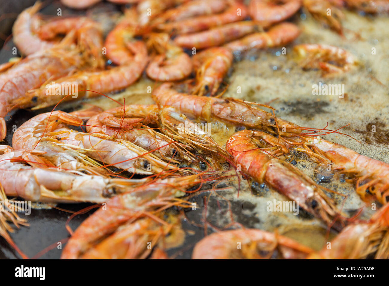 fast food cooking shrimps in boiling oil closeup outdoor Stock Photo