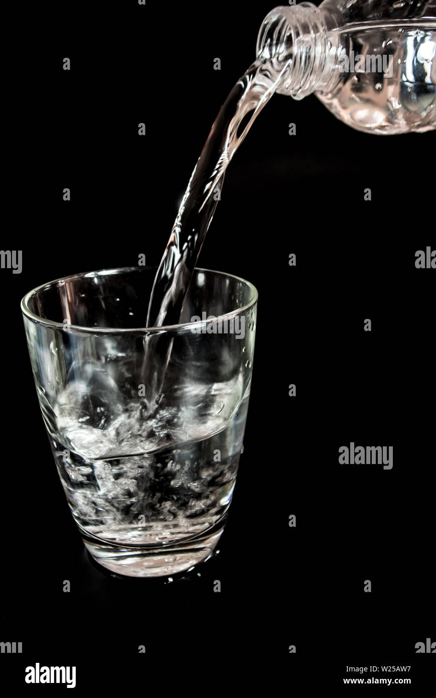 Pour water from the bottle into the glass Stock Photo Alamy