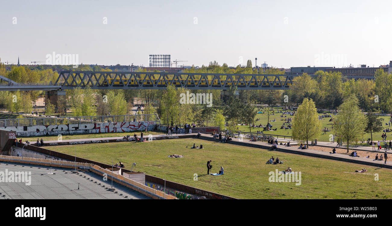 BERLIN, GERMANY - APRIL 18, 2019: People have a rest in Schoneberger Meadow park, American Church in the background. Berlin is the capital and largest Stock Photo