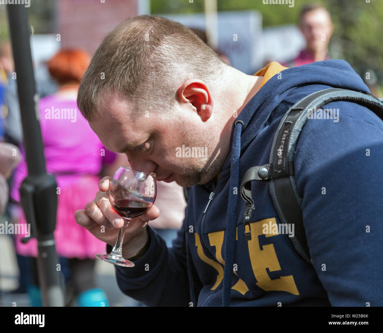 KYIV, UKRAINE - APRIL 21, 2019: People tasting wine during Food and Wine Festival in National Expocenter, a permanent multi-purpose exhibition complex Stock Photo