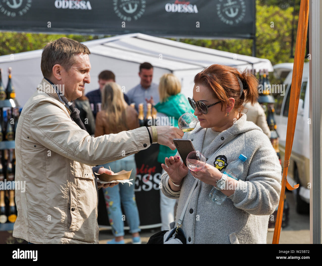 KYIV, UKRAINE - APRIL 21, 2019: People tasting wine during Food and Wine Festival in National Expocenter, a permanent multi-purpose exhibition complex Stock Photo