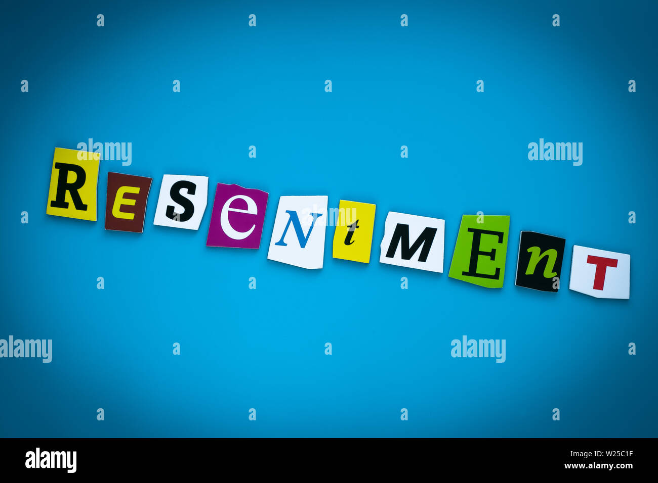 Single word - resentment. Text on blue background from colorful letters. Psychologic concept. Message on poster. Headline, caption, heading on card Stock Photo