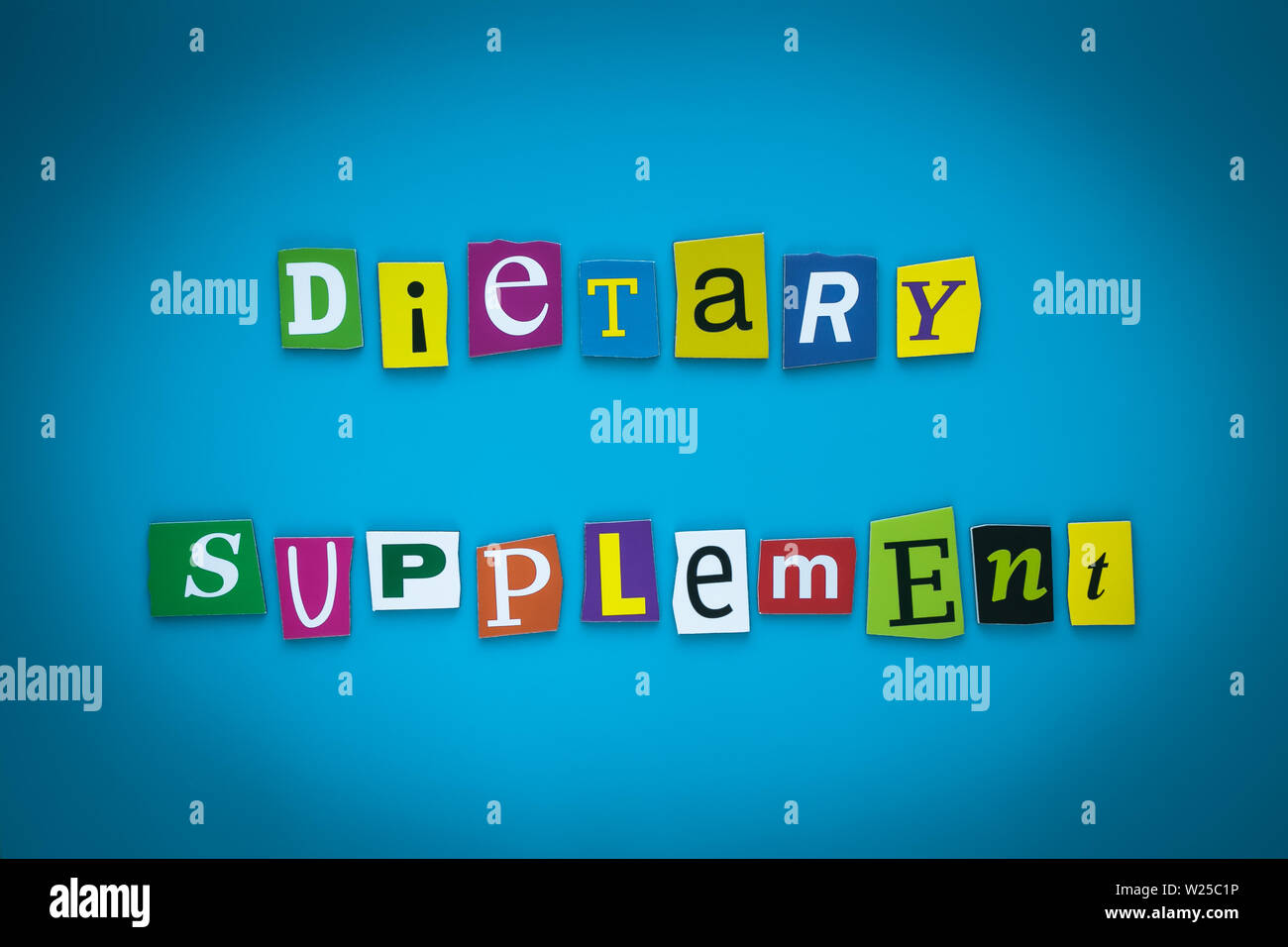 Text - Dietary Supplement on blue background from colorful letters. Card with an inscription. Headline, caption, heading on banner. Letter on bright Stock Photo
