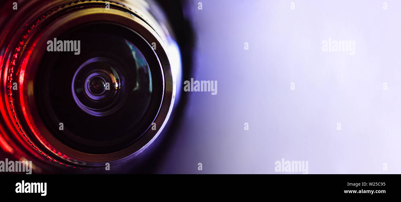 Camera lens and red backlight . Horizontal photography. Banner Stock Photo