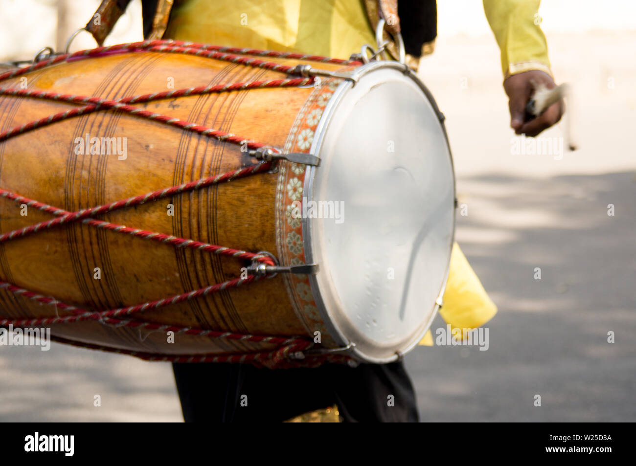 Dhol drummer playing this traditional indian instrument in the