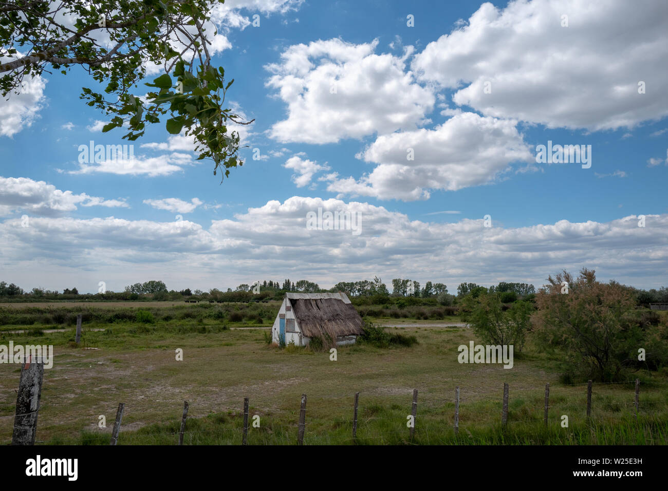 Typical cottage home of Gardian cowboy in Camargue, France, with sky and trees. Stock Photo