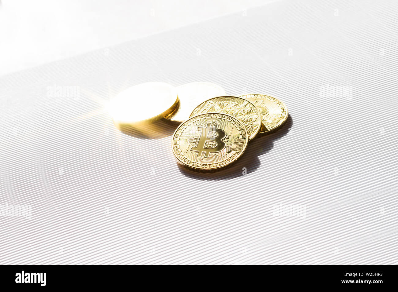 Gold shiny coins with a bitcoin symbol on white background. Concept of business and finance in internet. Virtual crypto currency. Stock Photo