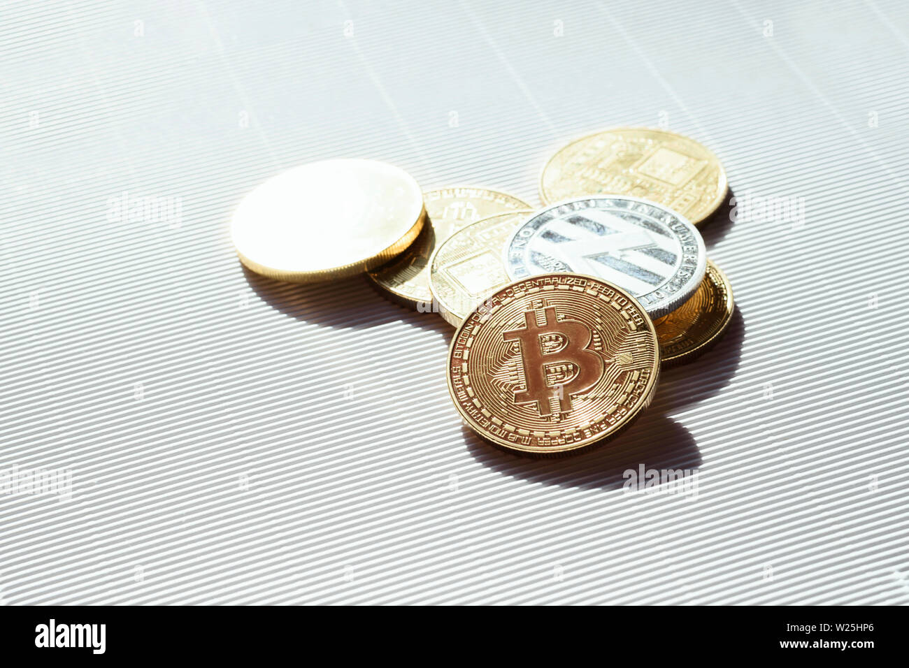 Gold and silver shiny coins with a bitcoin and lisk symbols - virtual crypto currency. Concept of trading and business in internet. Stock Photo