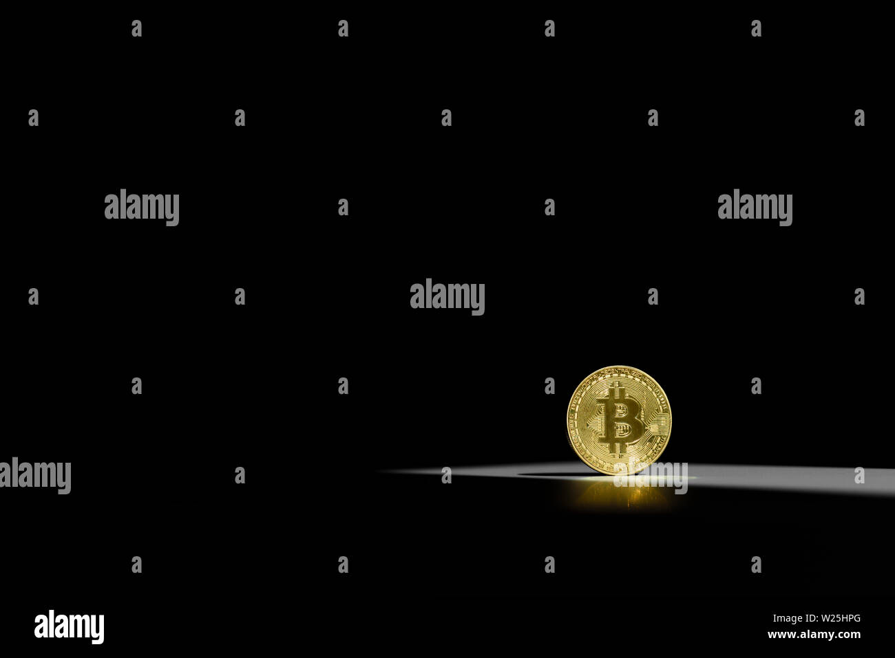 Gold shiny coin with a bitcoin symbol in a sun light with shadow around. Concept of business and finance in internet. Virtual crypto currency. Success Stock Photo
